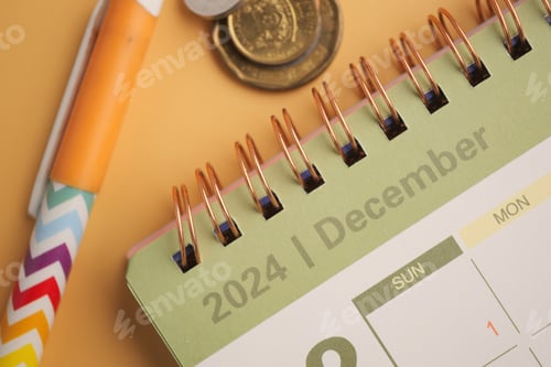 Preview: The December 2024 Calendar features a Pen and Coins on a vibrant Yellow Background