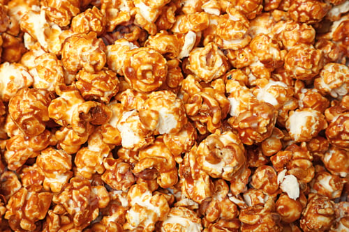 Preview: Sweet tasty caramel popcorn as background, top view