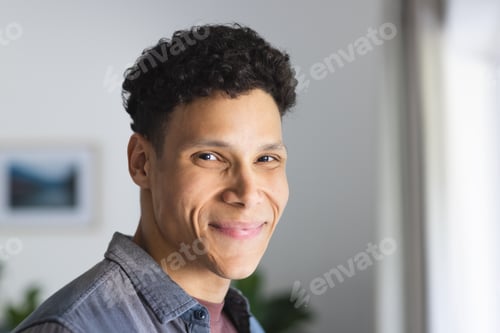 Preview: Portrait of happy biracial man in living room at home, copy space