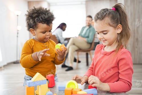Preview: Multiracial family enjoying playtime at home with colorful blocks