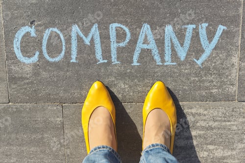 Preview: Company concept, top view on woman legs and text written in chalk on gray sidewalk