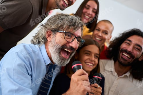 Preview: Funny Caucasian family playing Sing Star karaoke holding microphones and singing together at home.
