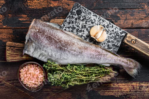 Preview: Fresh Raw cod or codfish fish on wooden board with cleaver. Dark Wooden background. Top view