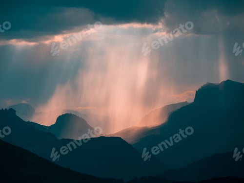 Preview: The rays of the sun broke through the threatening clouds over mystical mountains in Dolomites,Italy