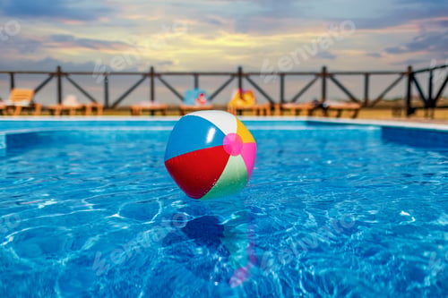 Preview: The ball floats on the water surface in the pool under the summer sun