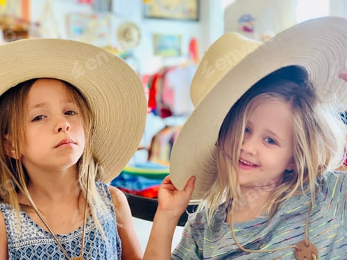 Preview: Two children play wearing very large hats