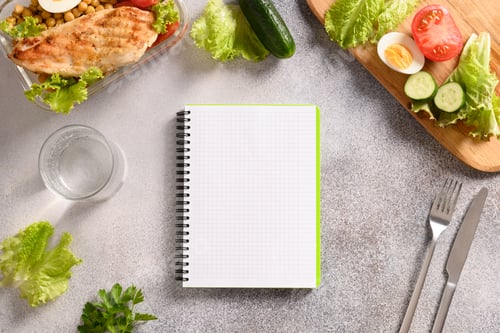 Preview: Notebook, food, salad, egg , water and vegetable.