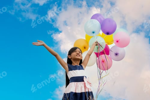Preview: Cheerful cute girl holding balloons run green meadow