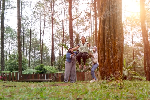 Preview: Joyful Friends Pushing a Swing in a Sunny Pine Forest Park