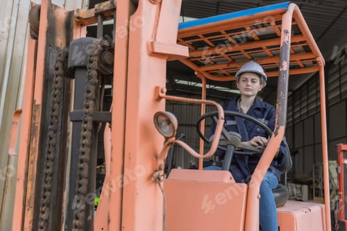 Preview: WoMan worker at forklift driver happy working in industry factory logistic ship