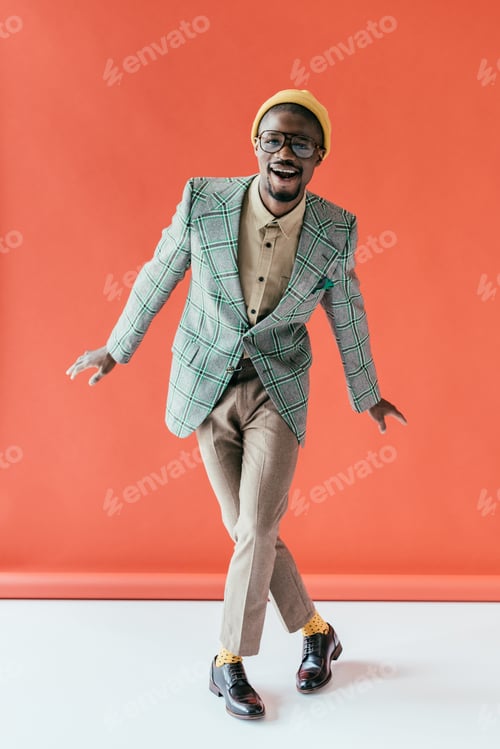 Preview: excited african american man in vintage jacket, on red