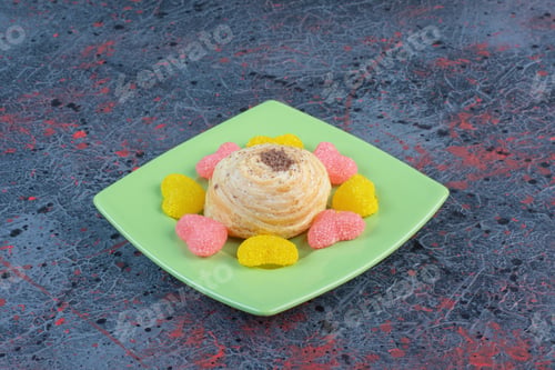 Preview: Flaky cake and marmalades on a green platter on abstract background