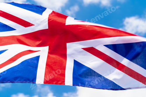Preview: United Kingdom Flag waving on wind in blue sky