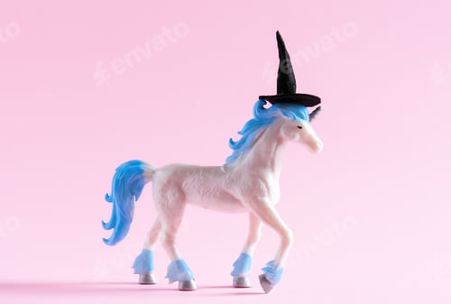Preview: Cute unicorn toy wearing witch hat on pink background. Minimal art poster for Halloween.