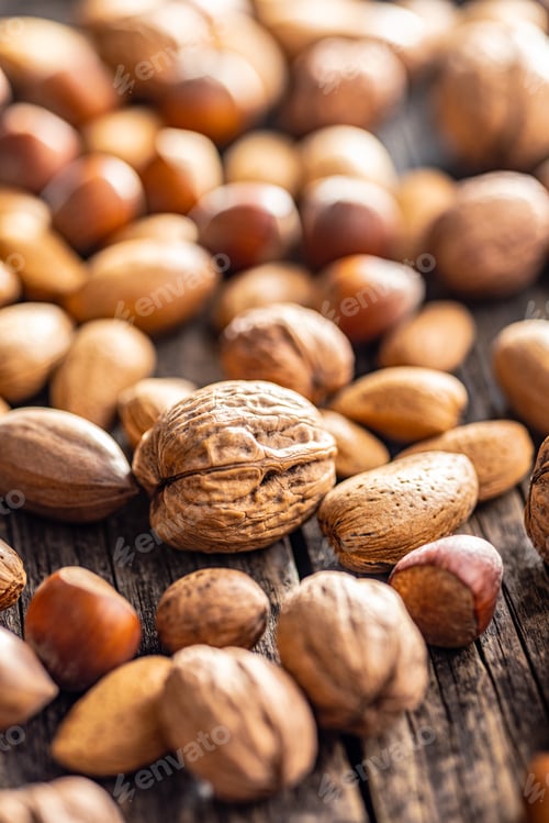 Preview: A mix of different nuts on wooden table.