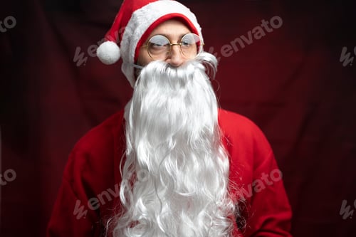Preview: Portrait of a traditional Santa Claus with a long white beard, wearing a classic red sui