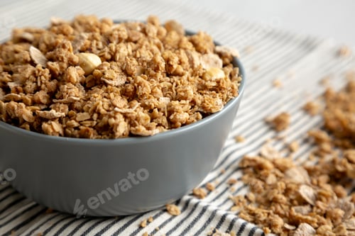 Preview: Healthy Homemade Toasted Muesli with Nuts in a Bowl, side view. Close-up.