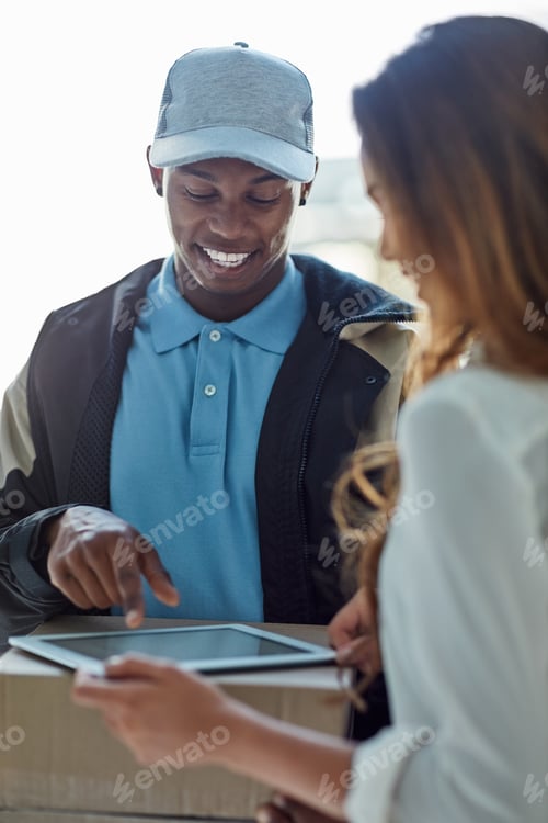 Preview: Cropped shot of a businesswoman using a tablet to sign for a package delivered to her office