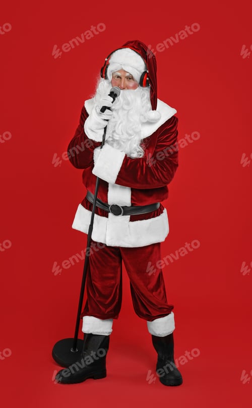 Preview: Santa Claus with headphones and microphone on red background. Christmas music