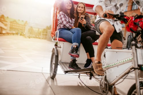 Preview: Young women sitting on tricycle and posing for selfie