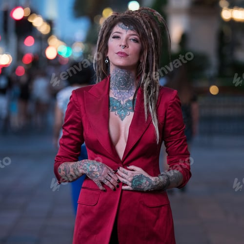 Preview: Beautiful woman with dreadlocks and tattoos wearing red business jacket