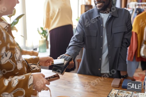 Preview: Female Customer Paying Wireless at Second Hand Store