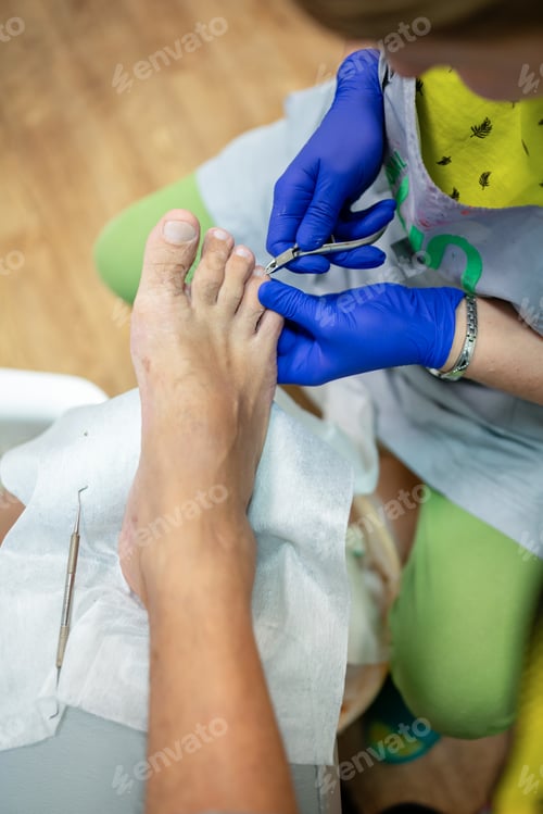 Preview: concept of male pedicure, cosmetologist makes classic pedicure for an elderly male client.