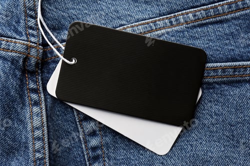 Preview: Cardboard tags with space for text on blue jeans, top view