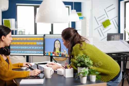 Preview: Art director consulting designer colleague, retouching woman portrait