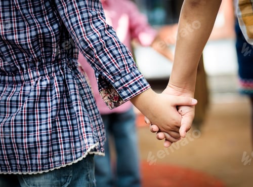 Preview: Group of diverse kindergarten students standing holding hands to