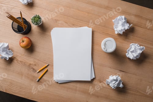 Preview: top view of stacked blank papers on wooden table with crumpled papers