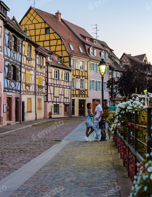 Preview: Couple men and women hugging at the Beautiful view of colorful romantic city Colmar, France, Alsace
