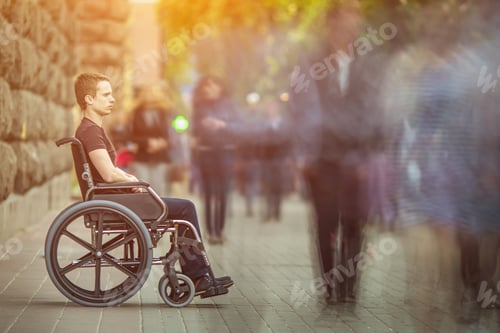 Preview: The invalid man sit in the wheel chair in the crowd stream at the pavement