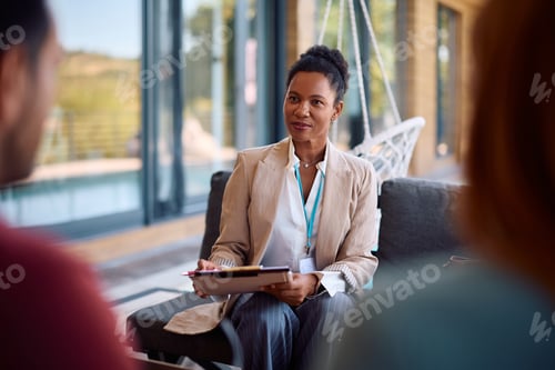 Preview: Black insurance agent having consultations with her clients who are buying a new home.