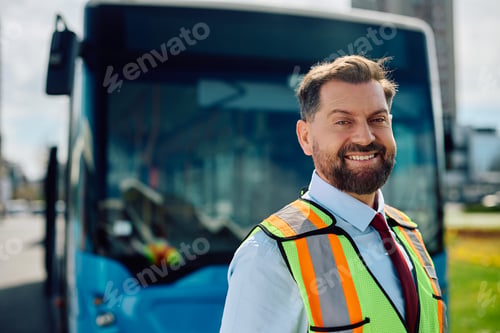 Preview: Happy bus driver in front of a vehicle looking at camera.