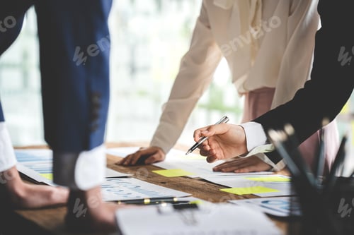 Preview: Teamwork with price chart analyzes business people on the table at the conference room.
