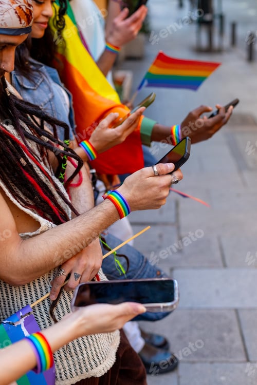 Preview: Activists using smartphones during pride parade demonstrating support for lgbtq plus rights