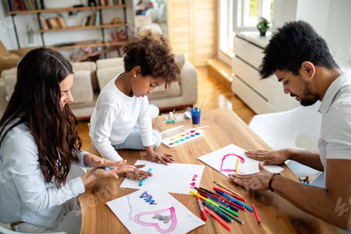Preview: Happy multiethnic family spending time together at home. Parent child education fun concept