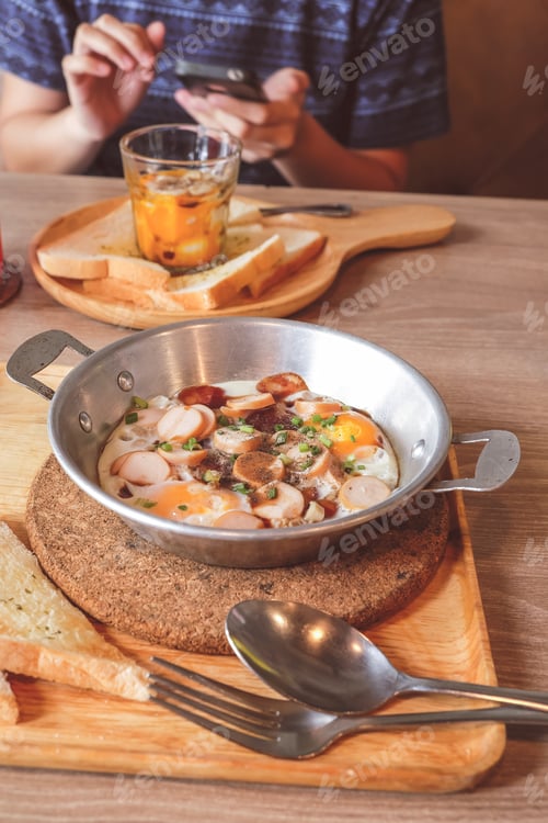 Preview: Breakfast Fried Eggs With Sausage And Toast In A Small Pan.