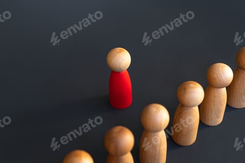 Preview: Red Wooden Figure Standing Out From Wooden Crowd