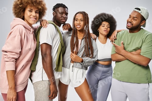 Preview: optimistic african american friends in sportswear standing together on grey backdrop, Juneteenth
