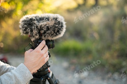 Preview: Closeup of the hand holding a microphone for filming.