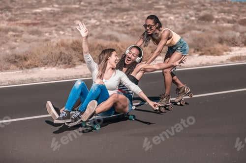 Preview: Happy ladies with long boards hugging on asphalt road