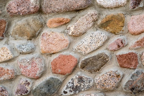 Preview: Flat detail view of a wall made from different stones. Abstract stone background.