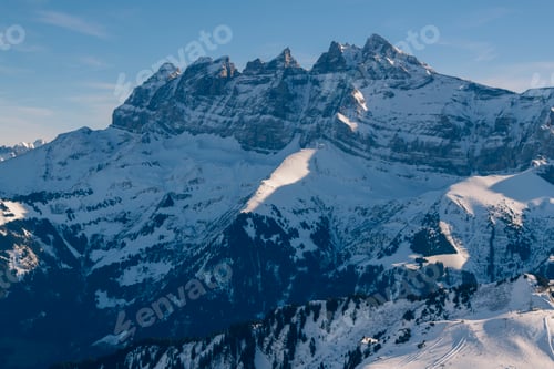 Preview: Beautiful snowcapped mountains with blue sky at the ski resort of Morzine in the Alps Mountain Range
