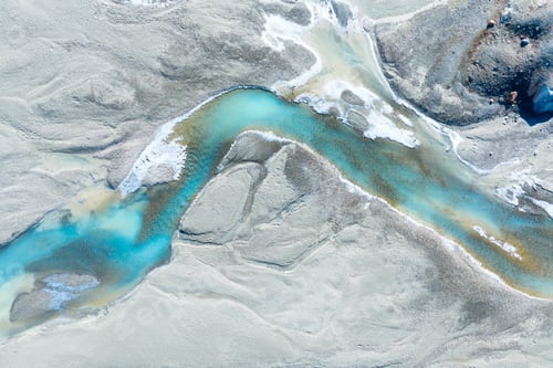 Preview: Drone view of the azure river in the glacier valley. View of the moraines.