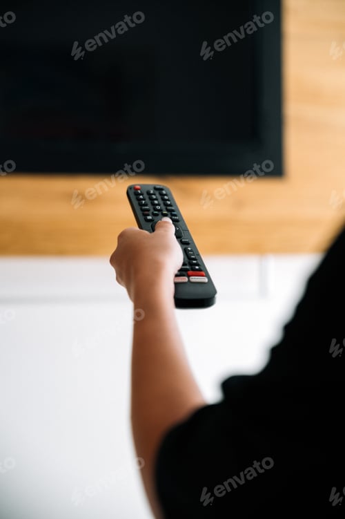 Preview: Unrecognizable woman turning on TV