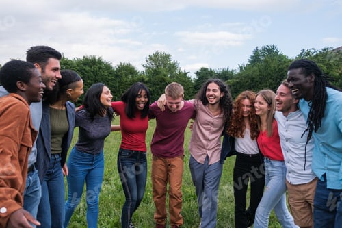 Preview: Group of young lifestyle people with different cultures having fun together in the park