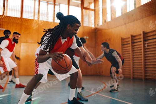 Preview: Arabic man basketball player dribbling the ball during game with his teammates