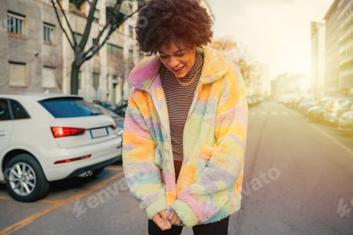 Preview: Young mixed race curly hair woman outdoor smiling